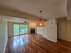 Boulder apartment for rent - an empty living room with wood floors and a fireplace