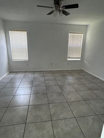 Killeen house for rent - an empty living room with a ceiling fan and tiled floor