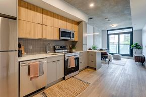 Edmonton apartment for rent - a kitchen with wooden cabinets and stainless steel appliances