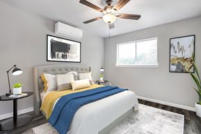 San Antonio apartment for rent - A bedroom with a bed, a ceiling fan, and a window.