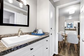 San Antonio apartment for rent - A bathroom with a sink, mirror, and a chair.