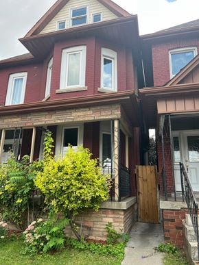 Hamilton apartment for rent - A red brick house with a wooden door and windows.