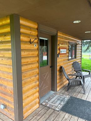 Whitefish apartment for rent - the front porch of a cabin with a chair and a door