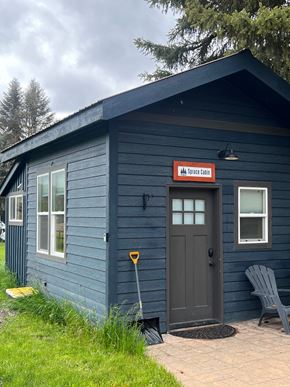 Whitefish apartment for rent - a blue building with a door and a sign on the side of it