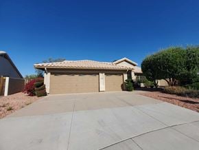 Chandler house for rent - a garage door with a driveway in front of a house
