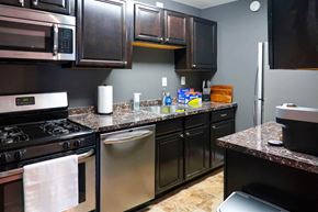 New Carrollton apartment for rent - a kitchen with stainless steel appliances and granite counter tops