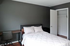 New Carrollton apartment for rent - a bedroom with a bed and a desk with a chair