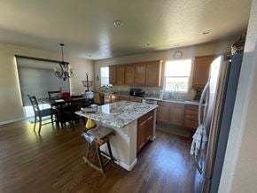 Castle Pines house for rent - a view of a kitchen with a island and a dining room
