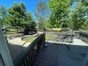 Castle Pines house for rent - a large deck with a bench and a yard with trees