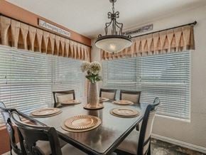 San Antonio house for rent - a dining room with a table and chairs and a chandelier