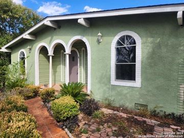 San Antonio apartment for rent - the front of a green house with a brick walkway