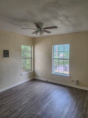 San Antonio house for rent - an empty living room with a ceiling fan and a window