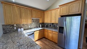 Gold River house for rent - a kitchen with wooden cabinets and a stainless steel refrigerator