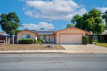 Merced house for rent - a house with a driveway and a garage door