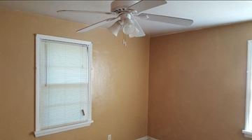 Ferguson house for rent - a bedroom with a ceiling fan and a window