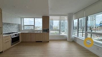 Burnaby house for rent - a kitchen with a stove and a large window
