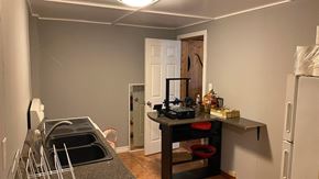 New Glasgow house for rent - a kitchen with a sink and a refrigerator and a door into a room
