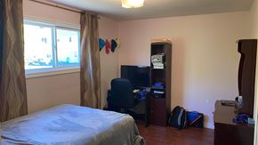 New Glasgow house for rent - a bedroom with a bed and a desk and a window