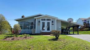 New Glasgow house for rent - the front of a house with a driveway and a basketball hoop