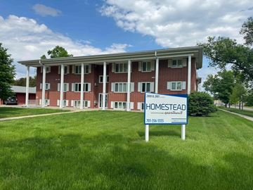 Fargo apartment for rent - a home sold sign in front of a building