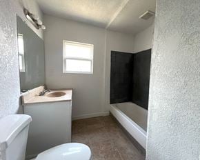 Kelso house for rent - an empty bathroom with a sink toilet and a bath tub