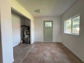 Kelso house for rent - the living room of a house with a green door