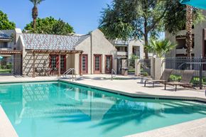 Glendale apartment for rent - A swimming pool in front of a building with a red door.