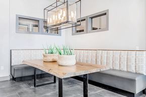Garland apartment for rent - A modern dining area with a wooden table and bench.