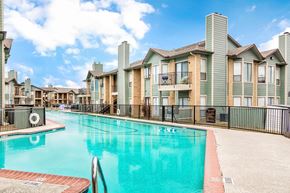Garland apartment for rent - A swimming pool in front of apartment buildings.