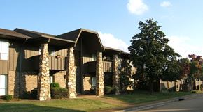 Jackson apartment for rent - a building with stone pillars and a tree in front of it