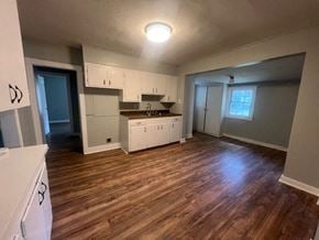 Hattiesburg house for rent - an empty kitchen and living room with a wooden floor