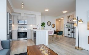 Calgary apartment for rent - A modern kitchen with a dining table and chairs.