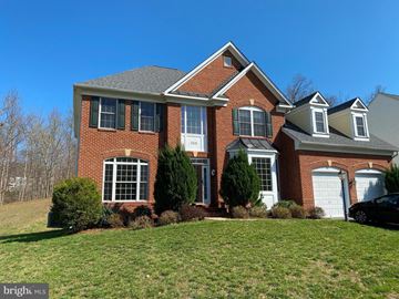 Triangle house for rent - a large brick house with a green lawn