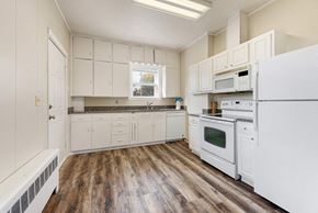 Mayer apartment for rent - a kitchen with white appliances and white cabinets