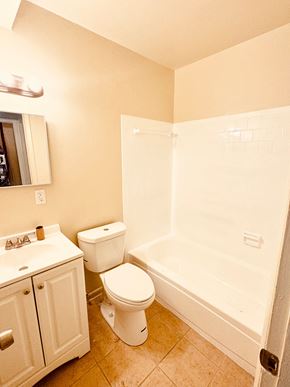 Washington apartment for rent - A white toilet sits next to a sink in a bathroom.