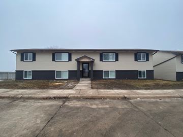 Kearney apartment for rent - a white house with black doors and windows and a sidewalk
