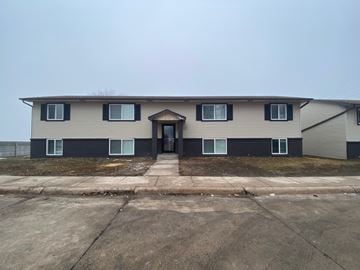 Kearney apartment for rent - a white house with black doors and windows and a sidewalk