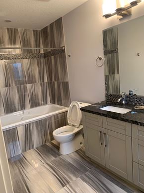 Fort Mcmurray apartment for rent - a bathroom with a toilet and a tub and a sink