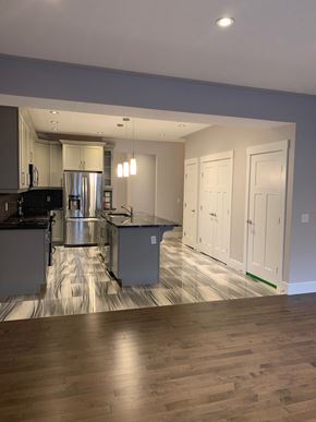 Fort Mcmurray apartment for rent - an open kitchen and living room with a hardwood floor