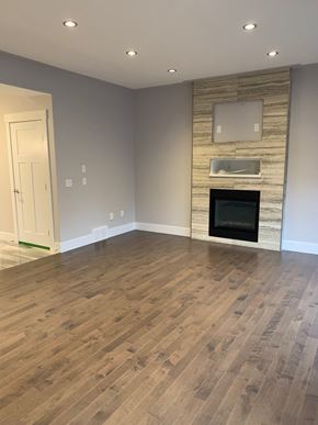 Fort Mcmurray apartment for rent - a living room with a fireplace and wooden floors