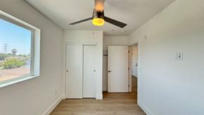 Los Angeles apartment for rent - A room with a ceiling fan and two doors.