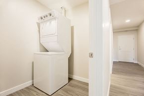 Edmonton apartment for rent - a white washer and dryer in a room with a door