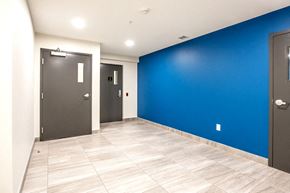 Edmonton apartment for rent - a room with a blue wall and two doors
