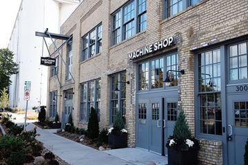 Minneapolis apartment for rent - the facade of the waching shop on the side of a brick building