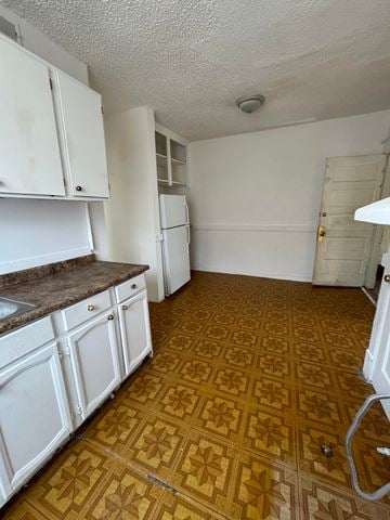 Saint Louis apartment for rent - a kitchen with white cabinets and a wooden floor
