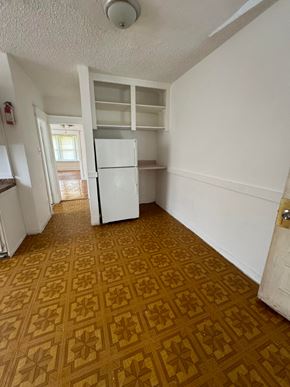 Saint Louis apartment for rent - an empty kitchen with a refrigerator and shelves
