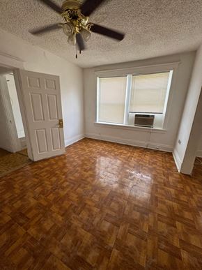 Saint Louis apartment for rent - an empty living room with wood floors and a ceiling fan