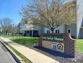 Williamsport apartment for rent - a city street manor sign in front of a building