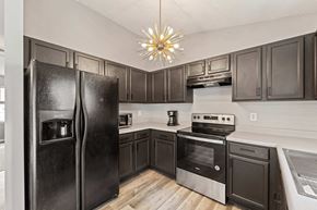 Richlands house for rent - a kitchen with stainless steel appliances and dark wood cabinets