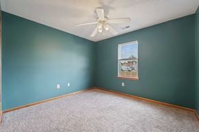 Richlands house for rent - a bedroom with blue walls and a ceiling fan